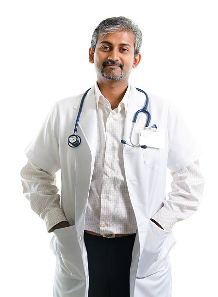 Brochure Download Indian doctor. Mature Indian male medical doctor standing isolated on white background. Handsome Indian model portrait.